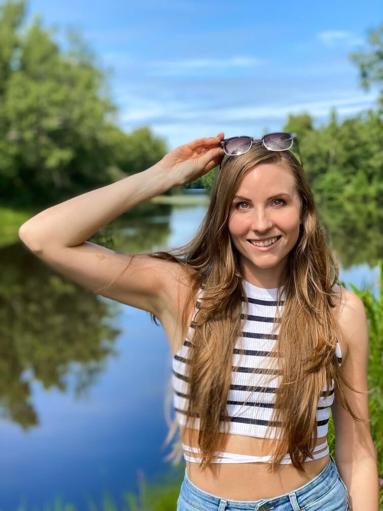Woman smiling by a lake