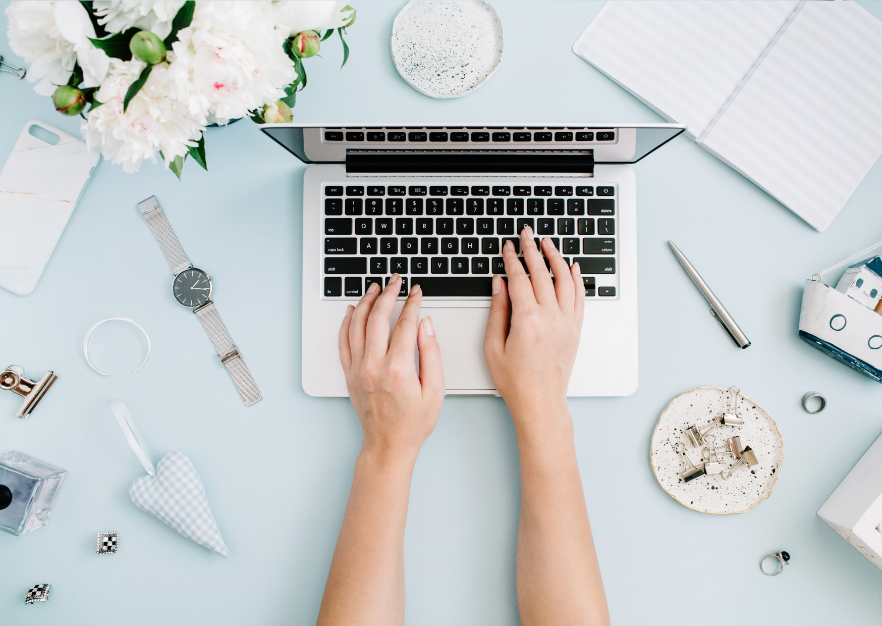 Person writing on a laptop
